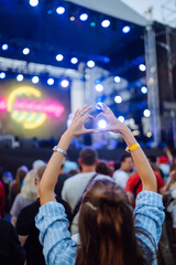 Fototapeta na wymiar Сrowd with raised hands at music festival. Summer holiday, vacation concept.
