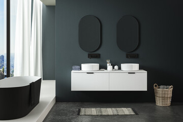 Fototapeta na wymiar Modern minimalist bathroom interior, modern bathroom cabinet, white sink, oval mirror, concrete flooring, bathroom accessories, bathtub, dark blue walls. 3d rendering 