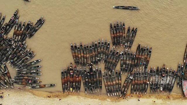 Aerial view of Jadukata River in Sylhet, Bangladesh. Locals are collection stone and sand from riverbed. Thousands of boats are lined up in the shore.