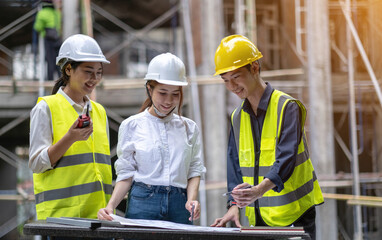 A diverse team of experts are planning on the construction site. Real estate project with civil...