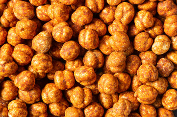 Roasted yellow chickpeas with chili pepper sauce, traditional spicy turkish nut, leblebi