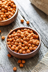 Roasted yellow chickpeas with chili pepper sauce, traditional spicy turkish nut, leblebi