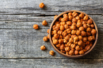 Roasted yellow chickpeas with chili pepper sauce, traditional spicy turkish nut, leblebi