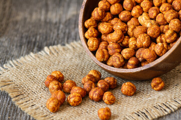 Roasted yellow chickpeas with chili pepper sauce, traditional spicy turkish nut, leblebi
