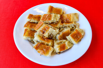Homemade burek (borek)  with cheese and spinach and boiled egg.Traditional food. Peynirli, Patatesli, kiymali kol boregi.