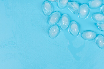 Cracked pieces of ice on a blue background. ice cubes