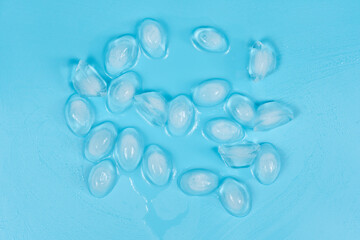 Cracked pieces of ice on a blue background. ice cubes