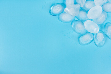 Cracked pieces of ice on a blue background. ice cubes