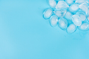 Cracked pieces of ice on a blue background. ice cubes