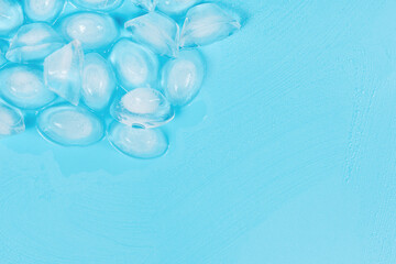 Cracked pieces of ice on a blue background. ice cubes