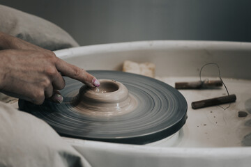 work in a pottery workshop. close-up of hands and potter's wheel