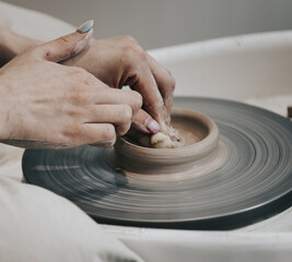work in a pottery workshop. close-up of hands and potter's wheel