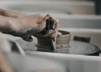 work in a pottery workshop. close-up of hands and potter's wheel