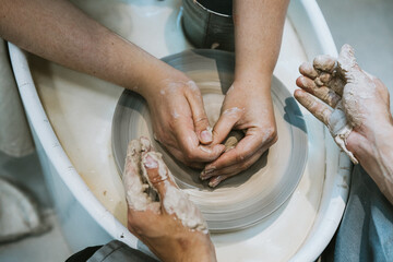 work in a pottery workshop. close-up of hands and potter's wheel