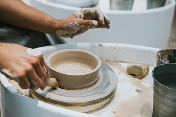 work in a pottery workshop. close-up of hands and potter's wheel