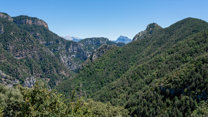 Fototapeta na wymiar forested canyon and gorge in a mountain range, the Anisclo Canyon, Ordesa National Park, Aragon Spain, blue sky