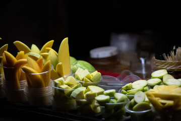 Fruits cut in the cup, Asian night street food market.