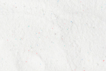 Laundry detergent for washing machines texture background. Washing powder. White wash powder with with colored granules