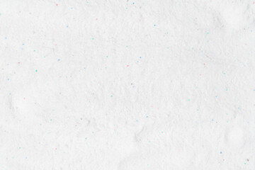 Laundry detergent for washing machines texture background. Washing powder. White wash powder with with colored granules