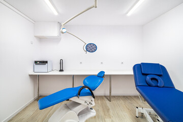 White interior of new modern clinic office with blue chairs and big lamp