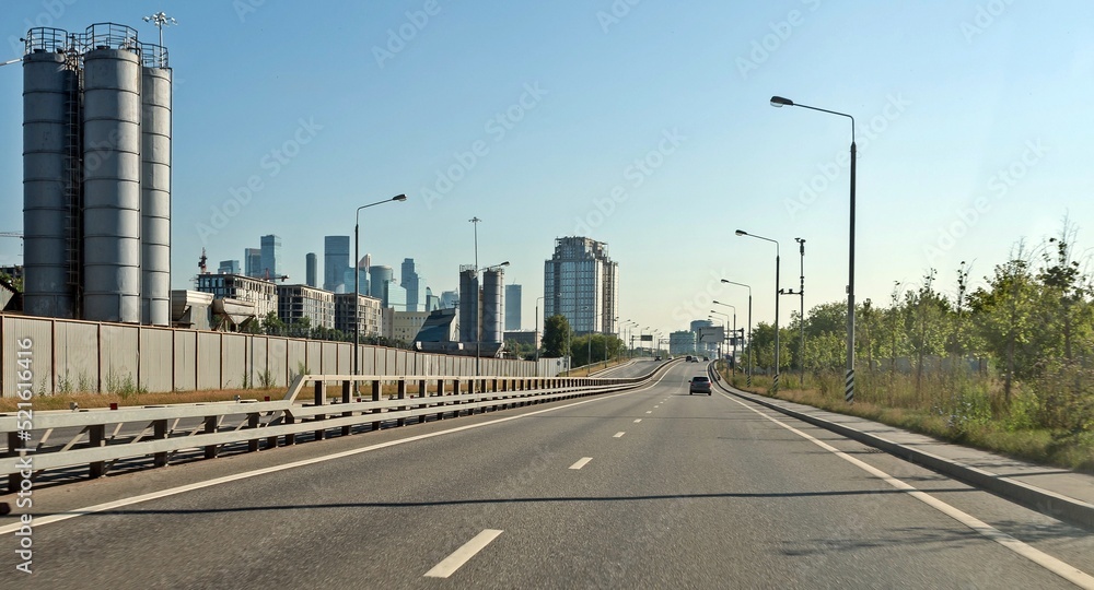 Wall mural two lanes on the road lead to the city