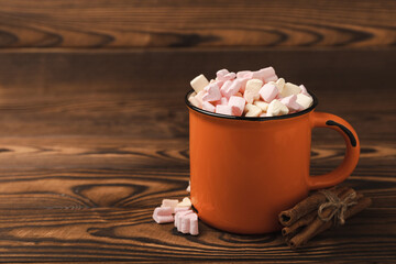 Cocoa drink on texture background. Hot chocolate with small marshmallows and spices. Winter warming drink concept. Space for copy. Space for text