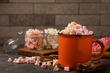 Cocoa drink on texture background. Hot chocolate with small marshmallows and spices. Winter warming drink concept. Space for copy. Space for text