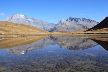 Amazing reflections in lake Plan du Lac Bellecombe looking towards La Grande Casse in the French alps