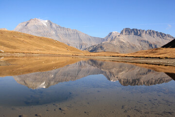 Amazing reflections in lake Plan du Lac Bellecombe looking towards La Grande Casse in the French alps