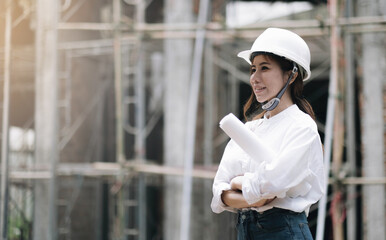 Female construction engineer. Architect with a tablet computer at a construction site. Young Woman...