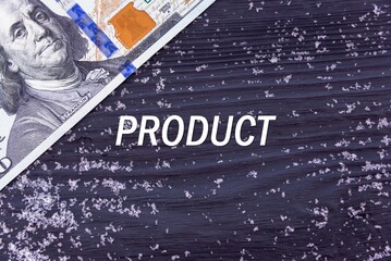 PRODUCT - word (text) on a dark wooden background, money, dollars and snow. Business concept (copy space).
