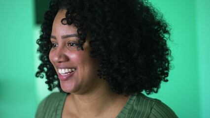 A black woman smiling face closeup with curly hair