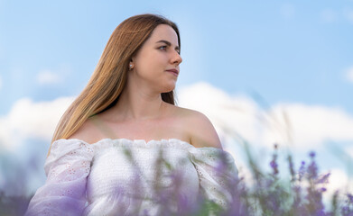 Fototapeta na wymiar Low angle portrait of woman in a field of lavender