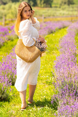 Cute young woman looking back as she walks through lavender