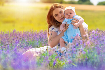 Little baby boy and his mother posing in lavender