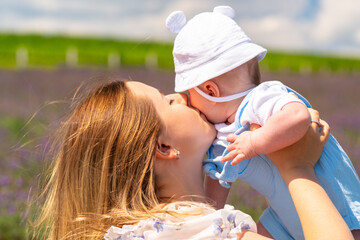 Tender portrait of a young mother kissing her baby