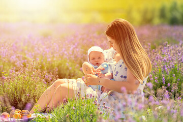 Sunset portrait of a young mother and baby son
