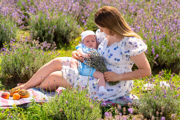 Young mother enjoying a summer picnic with her baby