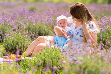 Young mother and her baby son enjoying a picnic