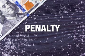 PENALTY - word (text) on a dark wooden background, money, dollars and snow. Business concept (copy space).