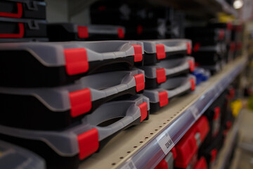 Empty tool boxes or containers for instruments on supermarket shelf. Building tools kit or case for order