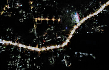 Birds eye view of main road at night time at the Banrak region of Koh Samui island in Thailand -aerial drone scene - higher altitude