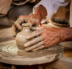 Potter at work makes ceramic dishes. India, Rajasthan. - 521630221