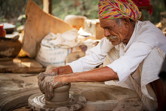 Potter at work makes ceramic dishes. India, Rajasthan.