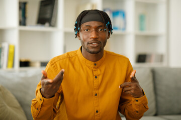 Portrait of a black man who gesticulates and talks to the camera, communicates via video call