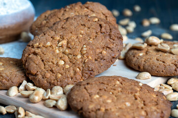 oatmeal cookies with peanuts on a black wooden table