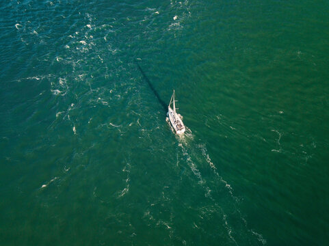 Aerial view of sailing yacht, racing across the sea, Hurst Point, The Solent, Keyhaven, Hampshire.