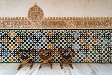 A hallway with Islamic inscriptions and three chairs - obrazy, fototapety, plakaty