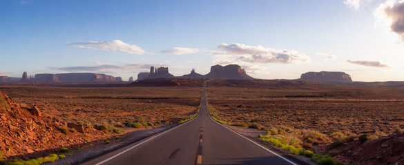 Scenic Road in the Dry Desert with Red Rocky Mountains in Background. Sunset Sky Art Render....