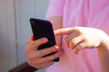 A man chooses a product on online marketplaces in summer